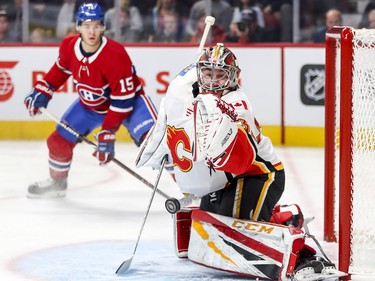 Jesperi Kotkaniemi watches as  Calgary Flames goalie David Rittich makes a save during first period in Montreal Tuesday, Oct. 23, 2018.