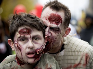Zombies walk the streets of Montreal during the annual Zombie Walk in Montreal on Saturday, Oct. 27, 2018.