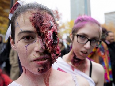 Justine Lessier, left, and Valérie Croteau take part in the annual Zombie Walk in Montreal on Saturday, Oct. 27, 2018.