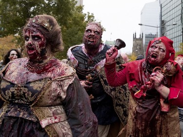 Zombies walk the streets of Montreal during the annual Zombie Walk in Montreal on Saturday, Oct. 27, 2018.