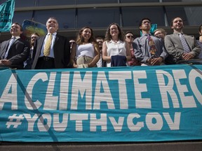 Lawyers and youth plaintiffs line up behind a banner on July 18 2018 after a hearing before Federal District Court Judge Ann Aiken between lawyers for the Trump administration and the so-called Climate Kids in Eugene, Ore. The young activists are suing the U.S. government in a high-profile climate change lawsuit.