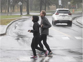 Runners cross Camillien Houde Way near Remembrance Rd. on Monday. The pilot project that was closed to car traffic since the early summer was deemed a success by Mayor Valérie Plante's administration.
