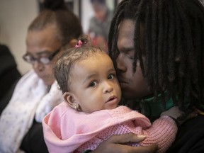 Angel Bartley Gibbs is comforted by Jeremy Gibbs, the victim's nephew, at a news conference announcing that the family is filing a civil suit against the city of Montreal.