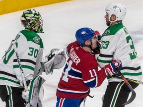 Stars goalie Ben Bishop watches the play as Canadiens' Brendan Gallagher battles Stars defenceman Marc Methot during third period Tuesday night at the Bell Centre.