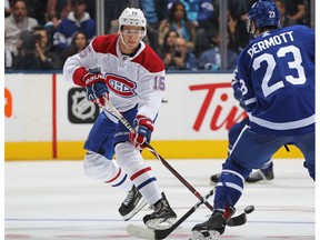 Jesperi Kotkaniemi of the Montreal Canadiens flips the puck in against Travis Dermott of the Toronto Maple Leafs at Scotiabank Place on Oct. 3, 2018, in Toronto.