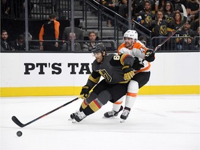 The Vegas Golden Knights’ Max Pacioretty battles with the Philadelphia Flyers' Andrew MacDonald to get to puck during NHL game at the T-Mobile Arena in Las Vegas on Oct. 4, 2018.