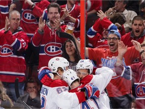 Canadiens' Phillip Danault (24) celebrates his first- period goal against the Senators with teammates Artturi Lehkonen (62) and Paul Byron (41) at Canadian Tire Centre on Saturday, Oct. 20, 2018, in Ottawa.