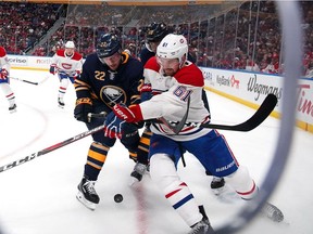 Sabres' Johan Larsson Canadiens' Xavier Ouellet #61 of the Montreal battle for the puck during the second period at the KeyBank Center in Buffalo Thursday night.