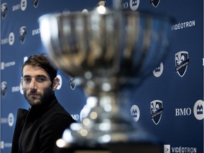 Montreal Impact's Ignacio Piatti looks at his MVP trophy during a press briefing in Montreal on Wednesday, Oct. 31, 2018.