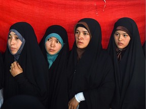 Afghan women attend an exhibition in Kabul. The garment they are wearing, the chador, is a rare sight in Quebec.