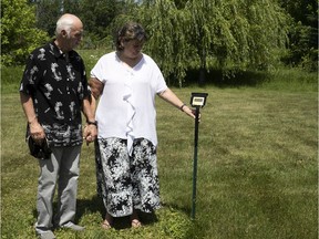 Céline Gravel and Claude Arnaud visit the communal grave where their son, Pierre-Martin, is buried at Laval Cemetery. For the couple, the metal stake with his name on it signifies that he is no longer anonymous — that finally, "he is someone,” his father says.