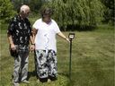 Céline Gravel and Claude Arnaud visit the communal grave where their son, Pierre-Martin, is buried at Laval Cemetery. For the couple, the metal stake with his name on it signifies that he is no longer anonymous — that finally, 