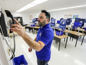 Vice-principal Dominique Caron hangs up the phone in a portable classroom attached to Ecole secondaire St-Laurent's St-Germain campus.