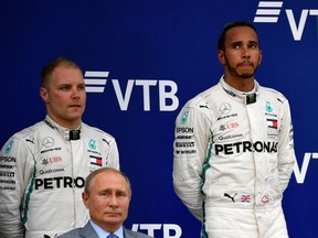 It was a sombre podium celebration for winner Lewis Hamilton and Mercedes teammate Valtteri Bottas in Sochi, with Russian President Vladimir Putin on hand to award the winner's trophy.