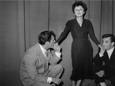 French singer Edith Piaf poses with American actor Eddie Constantine (left) and French singer Charles Aznavour in Paris in 1950.