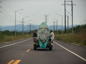 Men transport a boat on a truck in Teacapan, Mexico, Oct. 22, 2018, before the arrival of Hurricane Willa.