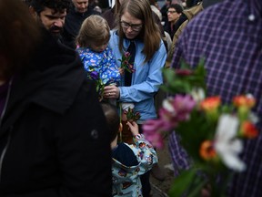 People arrive to pay their respects in front of a memorial on Sunday, Oct. 28, 2018, outside of the Tree of Life synagogue after a shooting there left 11 people dead in the Squirrel Hill neighbourhood of Pittsburgh on Saturday, Oct. 27, 2018.