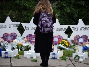 A woman stands at a memorial outside the Tree of Life synagogue in Pittsburgh after a shooting there left 11 Jewish people dead Oct. 27.