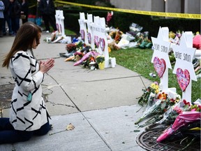 People pay their respects at a memorial outside the Tree of Life synagogue after a shooting there left 11 people dead in the Squirrel Hill neighborhood of Pittsburgh, Pennsylvania on October 29, 2018. - Mourners held an emotional vigil Sunday for victims of a fatal shooting at a Pittsburgh synagogue, an assault that saw a gunman who said he "wanted all Jews to die" open fire on a mostly elderly group. Americans had earlier learned the identities of the 11 people killed in the brutal assault at the Tree of Life synagogue, including 97-year-old Rose Mallinger and couple Sylvan and Bernice Simon, both in their 80s. Nine of the victims were 65 or older.