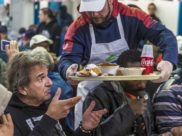 Members of the Alouettes like Jean-Gabriel Poulin were at the Welcome Hall Mission in Montreal on Monday, Oct. 8, 2018 to serve Thanksgiving Day turkey dinner to Denis Lamarche and others.
