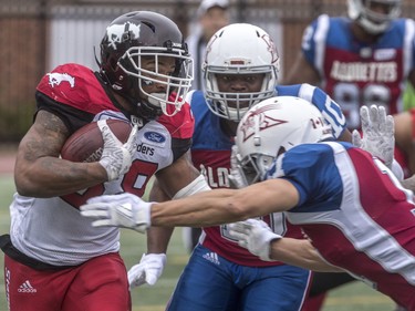 Calgary Stampeders running back Terry Williams tries to break through the Montreal Alouettes defensive line during first-half CFL action at Molson Stadium in Montreal on Monday, Oct. 8, 2018.