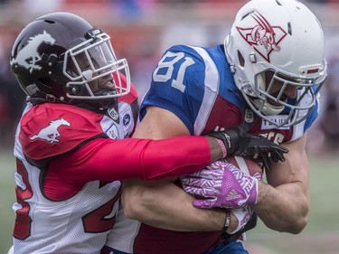 Calgary Stampeders defensive back Brandon Smith attempts to pry the ball from Montreal Alouettes fullback Patrick Lavoie during second-half CFL action at Molson Stadium in Montreal on Monday, Oct. 8, 2018.