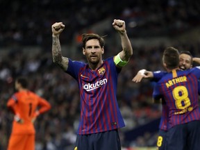 Barcelona forward Lionel Messi, center, celebrates after scoring his side's third goal during the Champions League Group B soccer match between Tottenham Hotspur and Barcelona at Wembley Stadium in London, Wednesday, Oct. 3, 2018.