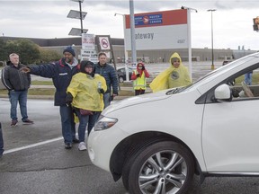 Striking Canada Post workers walk the picket line in Mississauga, Ontario on Tuesday October 23, 2018.