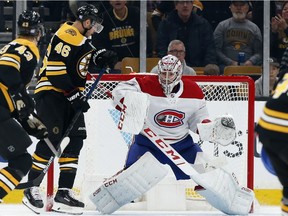 Canadiens goaltender Carey Price makes a save next to Bruins' David Krejci (46) on Saturday, Oct. 27, 2018, in Boston.
