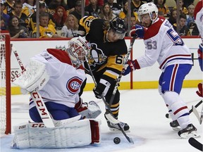 Pittsburgh Penguins' Carl Hagelin cannot get a rebound past Montreal Canadiens goaltender Carey Price with Victor Mete (53) defending during the second period  in Pittsburgh on Saturday, Oct. 6, 2018.