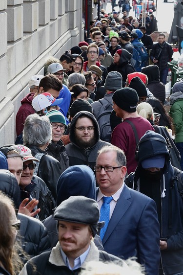 People line up on Metcalfe St. in Montreal Oct. 17, 2017, to buy legal cannabis at the SQDC outlet on Ste-Catherine St.