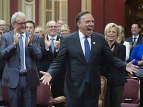 Quebec premier- designate François Legault reacts to the applauding crowd as he arrives to be sworn in as member of the National Assembly on Tuesday.