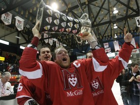McGill Redmen's captain Evan Vossen, who scored the game winner in OT, alongside assistant captains Maxime Langelier-Parent (L) and Marc-Andre Doiron celebrate their CIS University cup gold medal victory, Sunday, March 25, 2012 in Fredericton, New Brunswick.