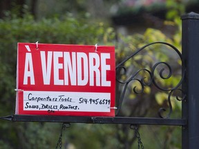 A home for sale sign is shown on the west island of Montreal, Saturday, November 4, 2017.