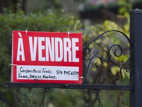 A home for sale sign is shown on the west island of Montreal, Saturday, November 4, 2017. Montreal's real estate market is continuing its hot streak.