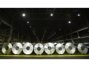 The federal government is imposing a 25 per cent surtax on some foreign steel products in a bid to buttress Canadian steel manufacturers and ward off dumping. Rolls of coiled coated steel are shown at Stelco in Hamilton, Ont., on June 29, 2018.