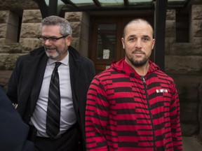 David Weaver, with his lawyer Blair Drummie, leaves the courthouse Old City Hall on bail in Toronto on Friday Oct. 19, 2018. The B.C. man faces an assault charge and garnered attention for allegedly stripping naked and plunging into a large shark tank at Ripley's Aquarium.