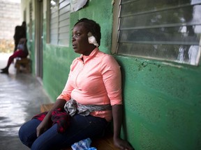 Shelda Similien, who ran out of her before it collapsed when a magnitude 5.9 earthquake hit the night before, waits to be treated at a local hospital in Gros Morne, Haiti, Sunday, Oct. 7, 2018. Similien's five year-old son died when he became buried by the rubble of the collapsed home.