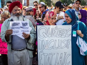 People take part in a protest against the proposed Charter of Quebec Values in Montreal on Sunday, September 29, 2013. Hearing Coalition Avenir Québec's plans, "I felt like someone hit reset and it was 2013, and the Charter of Values had just been announced," Fariha Naqvi-Mohamed writes.