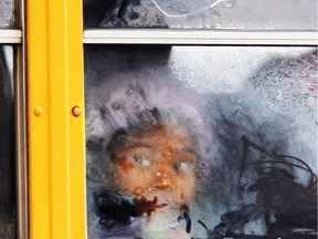 A student looks out the frosted window of a school bus as it moves down 19th Street, Tuesday, Jan. 7, 2014 in Philadelphia. The record-breaking polar air that has made the Midwest shiver over the past few days spread to the East and South on Tuesday, sending the mercury plunging into the single digits and teens from Boston and New York to Atlanta, Birmingham, Nashville and Little Rock _ places where many people don't know the first thing about extreme cold.