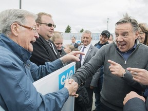 CAQ Leader François Legault, right, greets a supporter during a campaign stop in Saint-Jean-sur-Richelieu, Que., Sunday, Sept. 30, 2018.