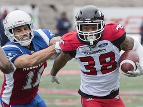 Alouettes' Chip Cox, left, tackles Stampeders' Terry William. "Every game I get to play is a blessing," the veteran Cox says.