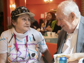 Enjoying a Thanksgiving lunch Friday, Chez Doris client Nora Mehringer sits with Andrew Harper, whose donation is making possible an expansion of Chez Doris's services.