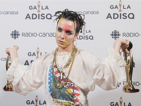 Hubert Lenoir holds up two of his three trophies at the Gala ADISQ awards ceremony in Montreal, Sunday, Oct. 28, 2018.