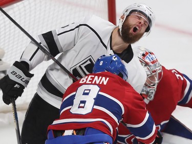 Los Angeles Kings' Jake Muzzin expresses his pain after being cross-checked by Jordie Benn during second-period NHL action in Montreal on Thursday, Oct. 11, 2018. Benn received a cross-checking penalty on the play.