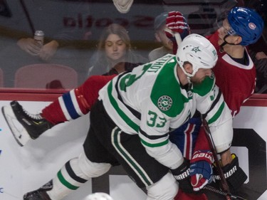Dallas Stars defenseman Marc Methot checks centre Jesperi Kotkaniemi into the boards during first period at the Bell Centre in Montreal on Tuesday, Oct. 30, 2018.