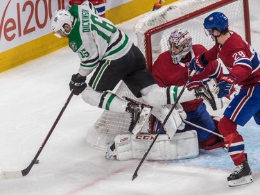 Dallas Stars centre Jason Dickinson goes flying in front of Carey Price thanks to a push from defenseman Mike Reilly during second period at the Bell Centre on Tuesday, Oct. 30, 2018.