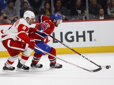 Defenseman Jeff Petry holds off Detroit Red Wings left wing Justin Abdelkader at the Bell Centre on Monday, Oct. 15, 2018.