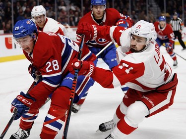 Defenseman Mike Reilly lets out a yell as he is hit by Detroit Red Wings centre Dylan Larkin at the Bell Centre on Monday, Oct. 15, 2018.