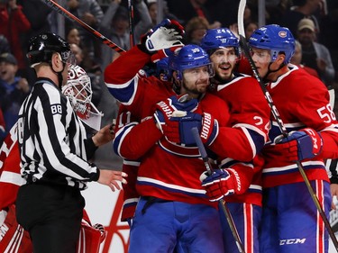 Phillip Danault, centre, Tomas Tatar and Noah Juulsen, right, celebrate Danault's goal against the Red Wings in Montreal on Monday Oct. 15, 2018.